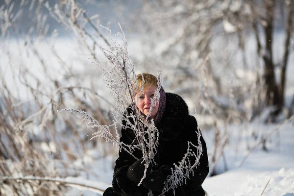 Russian woman posing in the winter at snowy park.