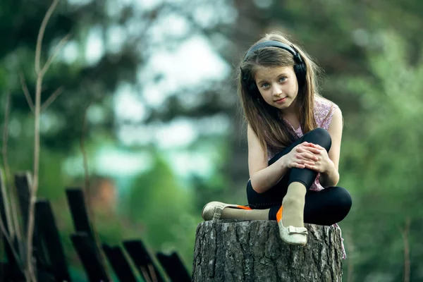 Little Cute Girl Headphones Sitting Stump Village Royalty Free Stock Images