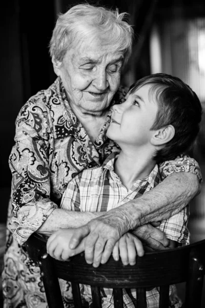 Grandmother and grandson posing for the camera. Black and white photography.