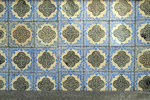 Traditional old tiles wall on the street Portuguese painted tin-glazed, azulejos ceramic tilework. Portugal.