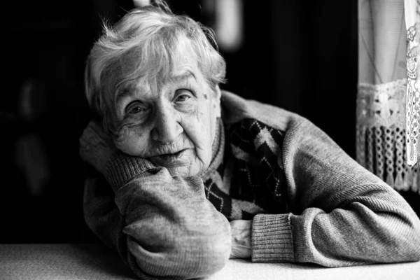 Portrait of an old woman. Black and white photography.