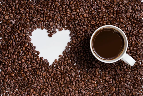 love of coffee, symbol of love, shape of heart from coffee beans with cup
