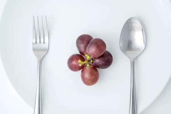 Health Eating Fruit Red Grape White Plate Fork Spoon Royalty Free Stock Images