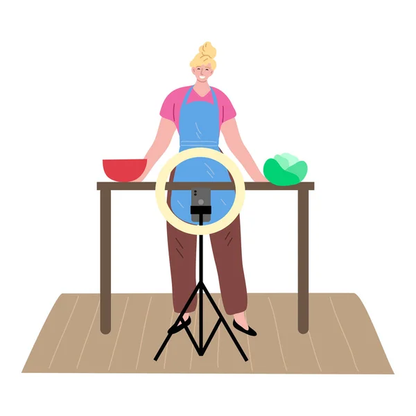 Женщина-блогер стоит на кухне и делает видео для кулинарного блога — стоковый вектор