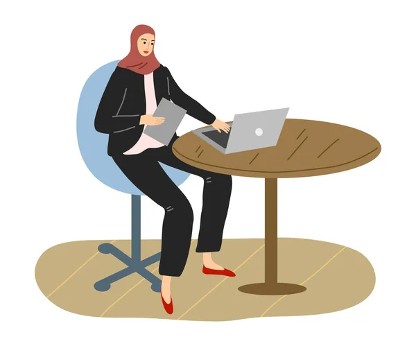 Young smiling muslim woman in hijab and business clothing working in office