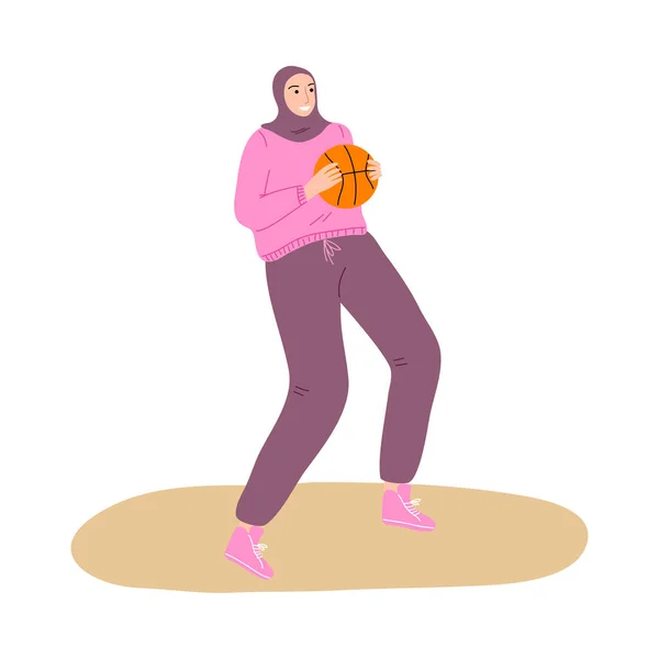 Young muslim woman in hijab and sport clothing playing basketball