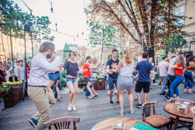 Lviv, Ukrayna-4 Ağustos 2018: Lviv pazar meydanında Diana Çeşmesi yakınında açık kafede salsa dansçıları