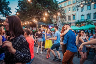 Lviv, Ukrayna-4 Ağustos 2018: Lviv pazar meydanında Diana Çeşmesi yakınında açık kafede salsa dansçıları