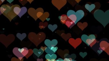 Renkli hareketli arka plan parlayan kalp parçacıkları. Şeffaf bokeh. Kusursuz 4K döngü video animasyonu. Açık pembe parıltılı ışıklar, çözülmüş ışık yansımaları döngüye girebilir bokeh arkaplan.