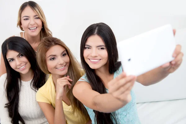 Happy young women laughing using smartphones