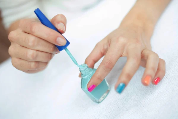 Natural hands painting her own nails