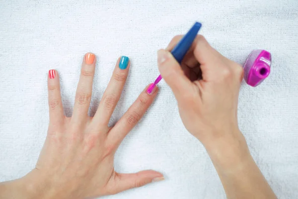 Natural hands painting her own nails