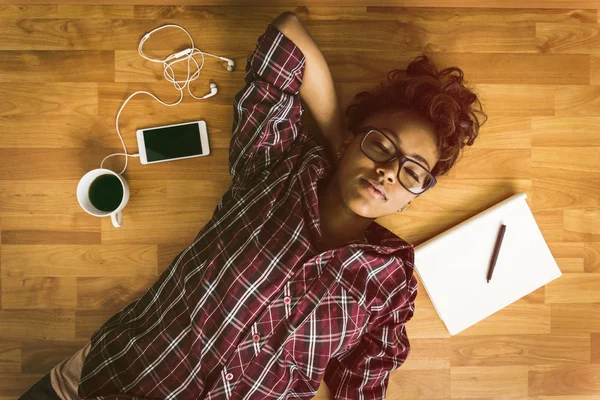 Beautiful hipster woman resting at floor