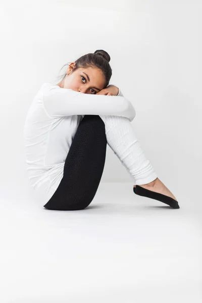 Toung latin ballerina sad and sitting on the floor