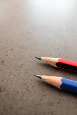 Bir koyu gri masada iki kalem