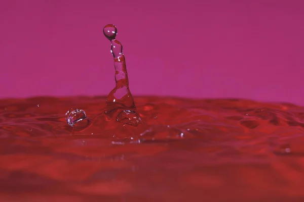 splash resulting from the impact of a drop with a container filled with water, freezing a fraction of a second