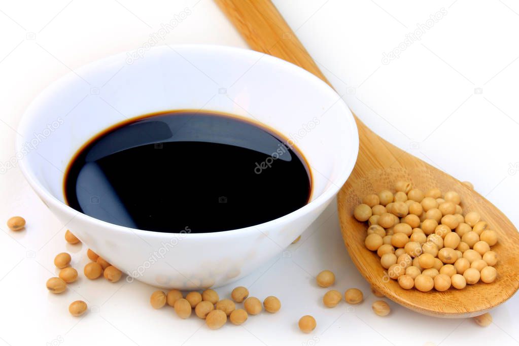 Soya beans with dark soy sauce in a ceramic bowl isolated over white background
