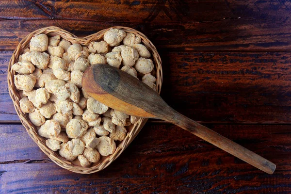 Soybean meat, chunks in a basket with heart shape. Top view of raw soybeans chunks on rustic wooden background