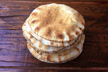 Rustik ahşap masada izole pide ekmek. Arap mutfağının geleneksel yemekleri