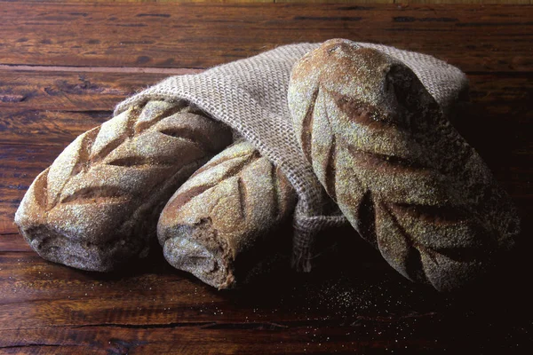 Australian bread inside rustic bag over rustic wooden background. Traditionally this bread is made with chocolate powder, brown sugar and honey