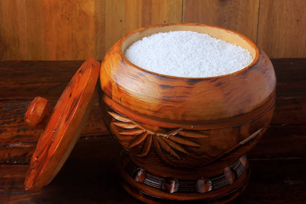 tapioca flour in wooden bowl on wooden background. Ingredient extracted from cassava