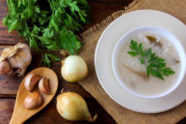 rustik ahşap masa üzerinde seramik kase içinde congee, Asya mutfağının tipik geleneksel pirinç lapası