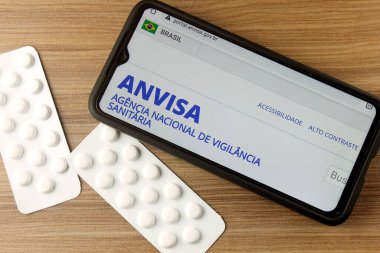 Rio de Janeiro, Brazil - September 10, 2020: ANVISA, National Health Surveillance Agency, on smartphone screen. In Brazil, it exercises sanitary control over all products and services clipart