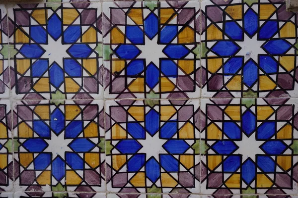 Portuguese traditional painted tin-glazed ceramic tiles Azulejos with colorful geometric ornament on the wall of building in Lisbon, Portugal