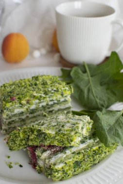 Spinach and raspberry cake with a cup of aromatic coffee. Beautiful and romantic breakfast