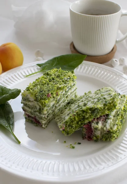 Spinach and raspberry cake with a cup of aromatic coffee. Beautiful and romantic breakfast