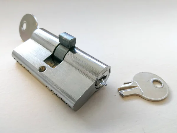 Broken key and lock with half of key inside close up