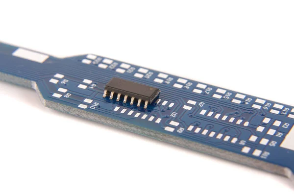 Small electronics integrated circuit IC on empty printed circuit board ready for hand assembly