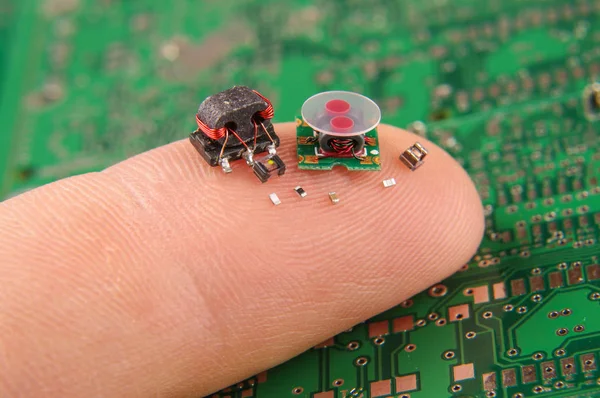Modern electronics surface mount components in comparison to human finger