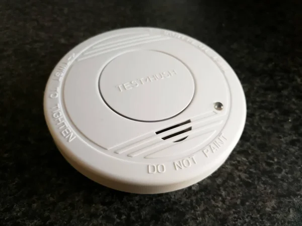 Plastic smoke alarm sensor isolated on the dark background