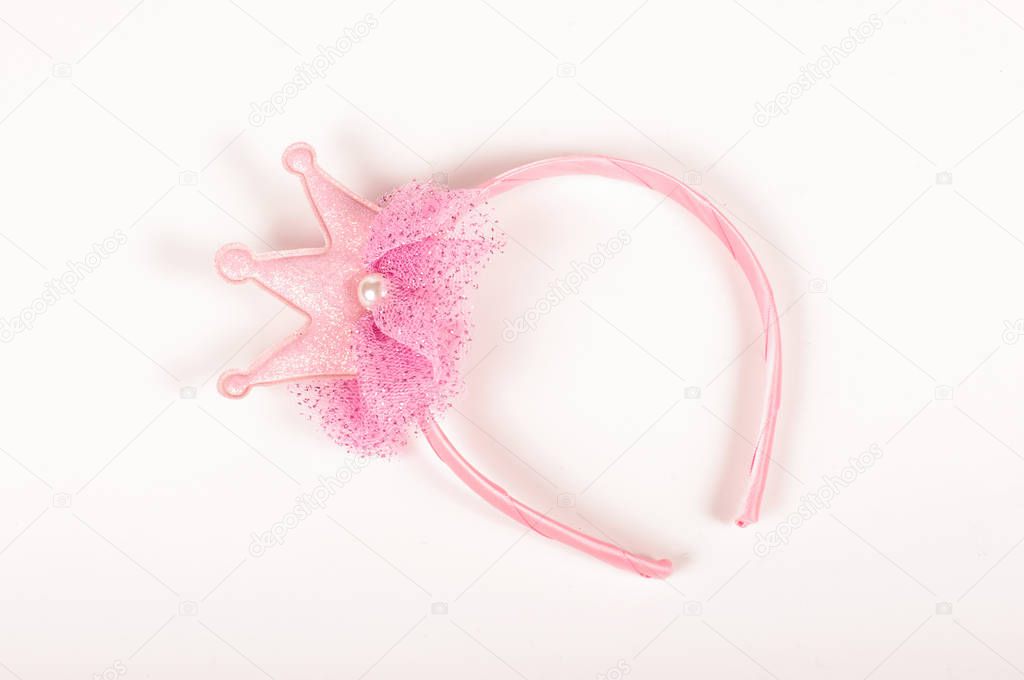 Pink princess headband on the white background for girls whose like role playing games