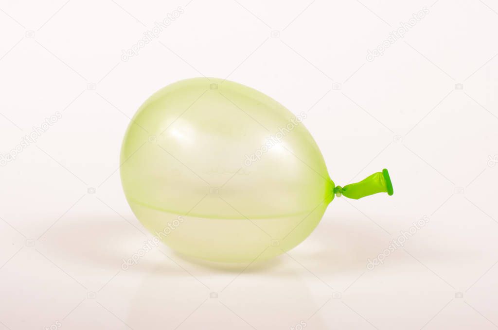 Green water bomb isolated on the light background