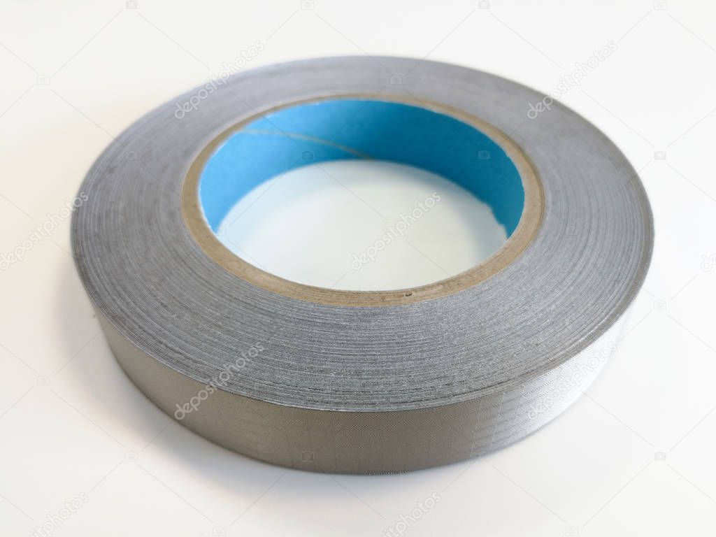 Conductive shielding textile tape for reducing electromagnetic emissions EMI isolated on the white background