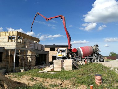 Çimento için endüstriyel çimento kamyonu inşaat alanında vinçle çalışıyor.