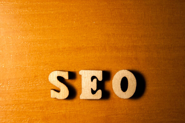 The word seo written with wooden letters background