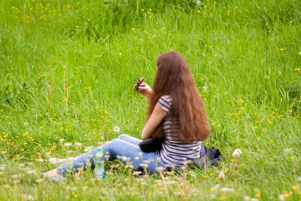 Młoda Dziewczyna Ciemnych Włosów Jest Siedzenie Fotelu Odpoczynek Łące Ręku — Zdjęcie stockowe