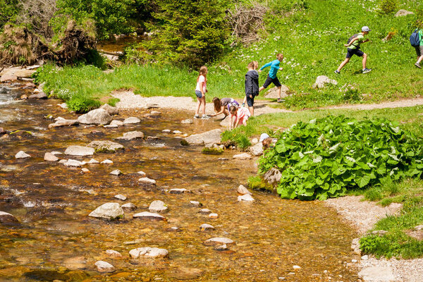 Children playing with water at a mountain stream. 28/05/2018, ' Koscieliska Valley' - Poland