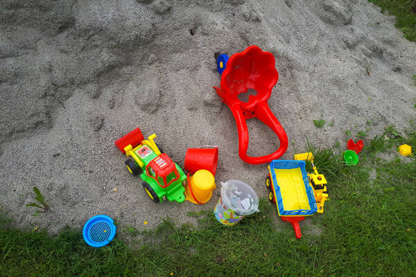 Sand toy on beach. Closeup pastic colorful toy for child. SToy items on the sand. childhood concept.