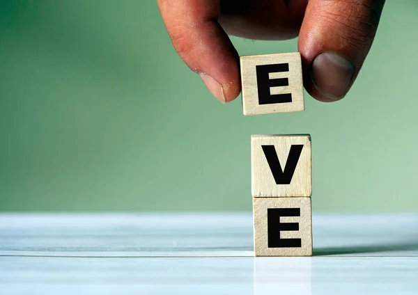 Hand Puts Cube Block Inscription Eve — Stock Photo, Image