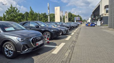 Rzeszow Poland - September 9 2025: A row of luxury cars displayed in a car dealership under a clear sky showcasing modern automotive design and elegance.