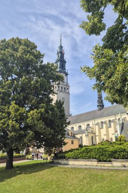 Czestochowa Poland - August 9 2025: A beautiful view of the Jasna Gora Monastery taken from a lush green park showcasing historical architecture and clear blue skies.