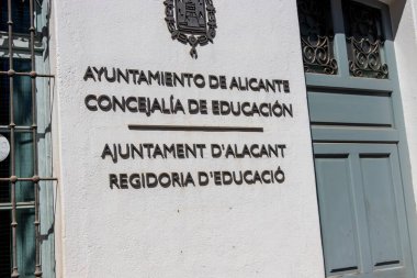 Alicante Spain - July 17 2025: The facade of the City Hall in Alicante showcasing educational services in Spanish and Catalan highlighting the city commitment to education.