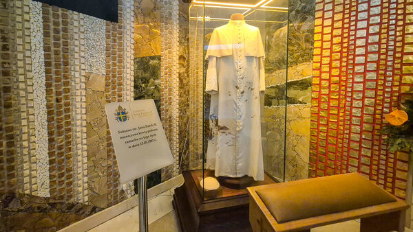 Czestochowa Poland - August 9 2025: A priests vestment displayed in a glass case at a religious exhibition highlighting the significance of religious garments in ceremonies.