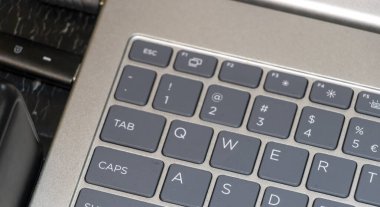 Close-up view of a laptop keyboard featuring various keys including function keys letters and punctuation marks showcasing the design and technology of modern devices.