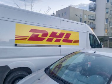 Rzeszow Poland - September 15 2025: A DHL delivery van parked on a street showcasing the brands iconic logo and colors symbolizing logistics and parcel delivery.