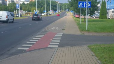 Rzeszow Poland - September 15 2025: A busy city street with vehicles and a bicycle lane showcasing urban traffic management and transportation infrastructure.
